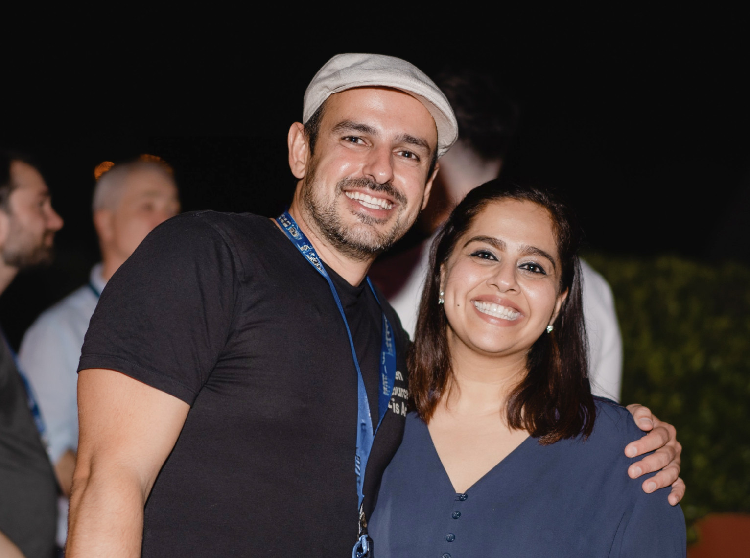 A female and a male employee smiling and posing together at a Nearform social event
