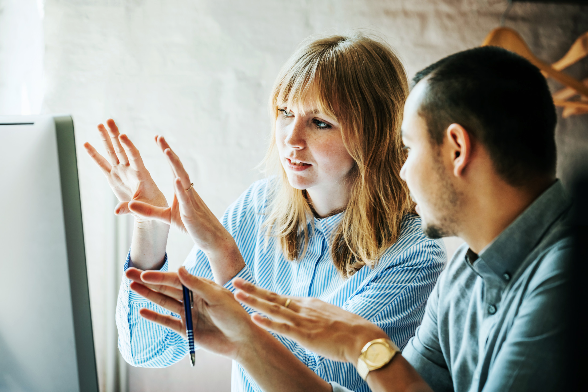 Customer Story - Colleagues problem solving at computer together